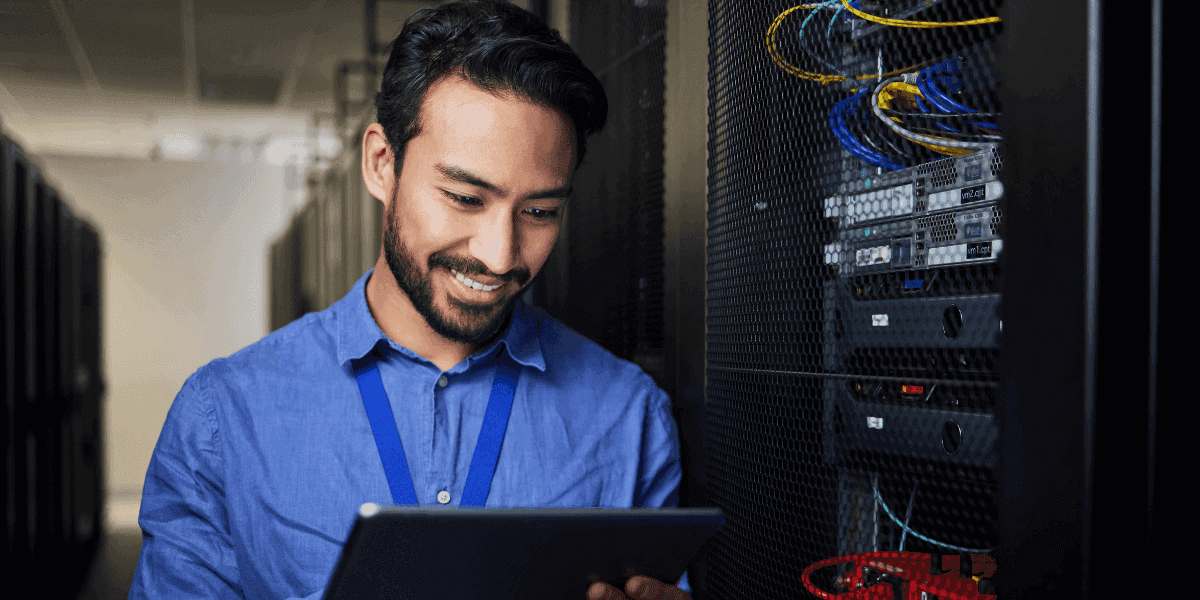 An IT specialist confidently maintaining servers, reflecting the stability and competitive salaries available in technology careers.