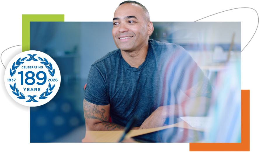 Building confidence and skills in a professional office setting Confident professional smiling while seated at a desk in a contemporary office environment