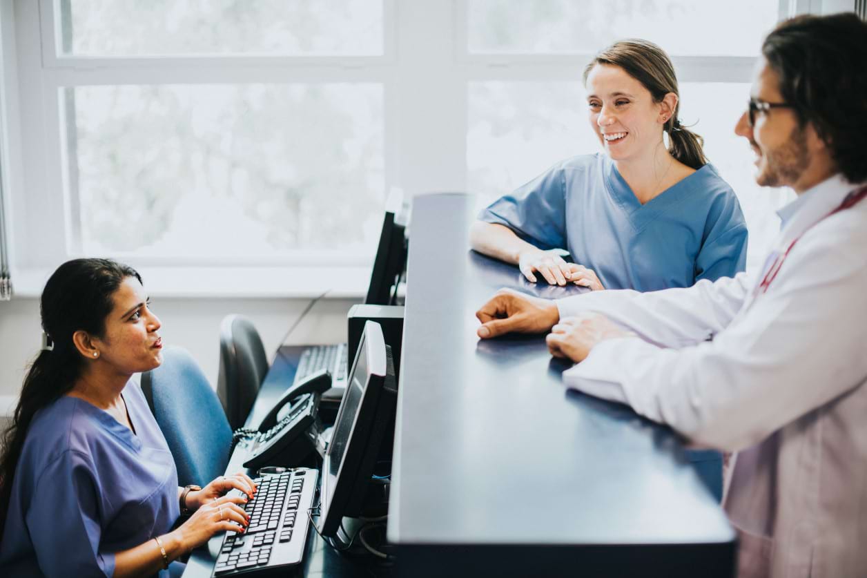 Healthcare administrators managing patient reception and records in a medical environment